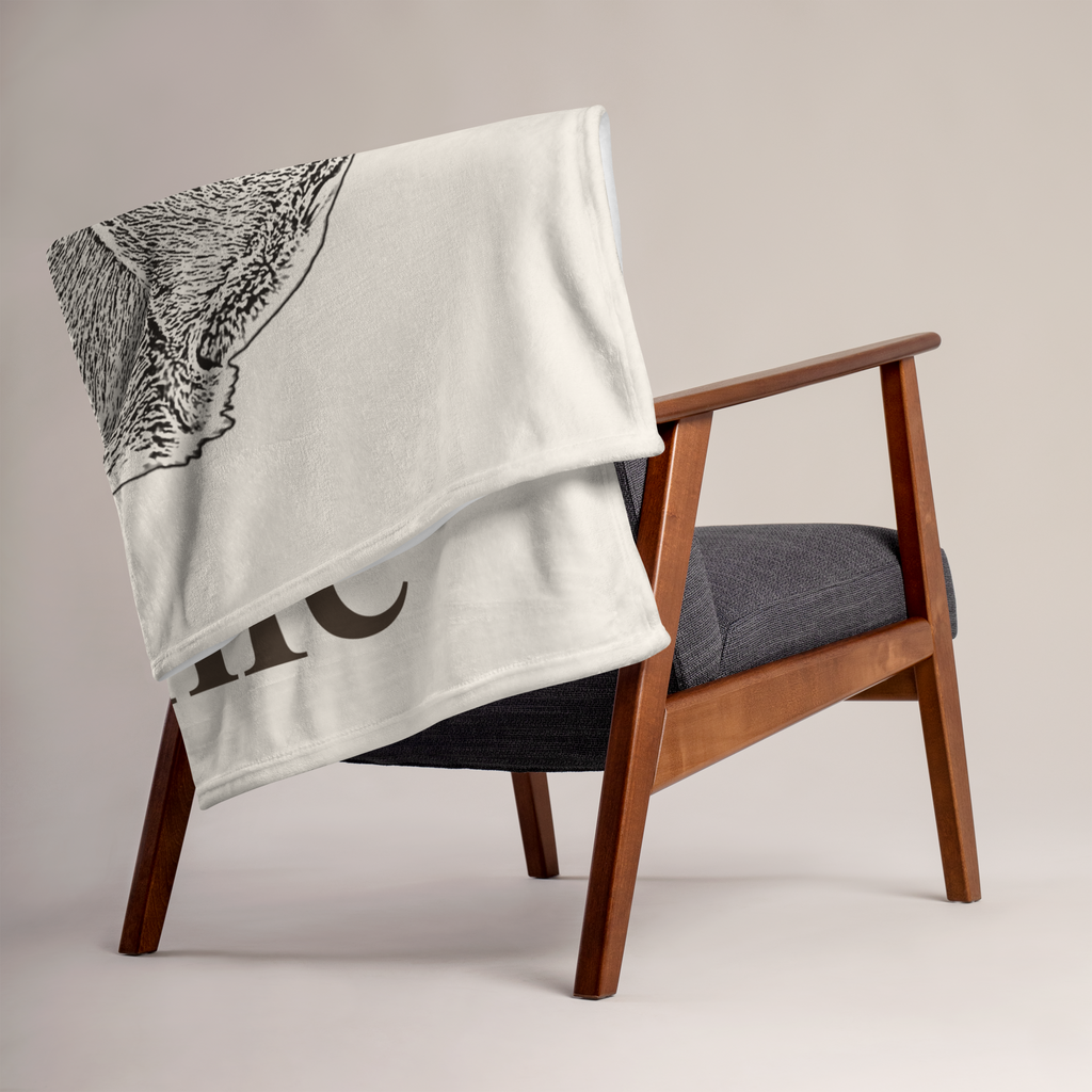 Personalised dog portrait blanket draped over an armchair