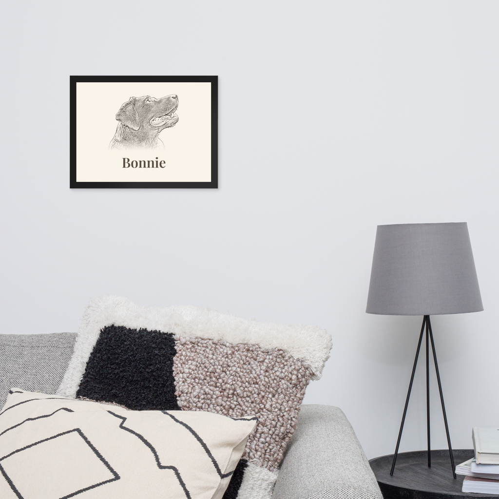 Personalised pencil sketch dog portrait in black frame above a sofa