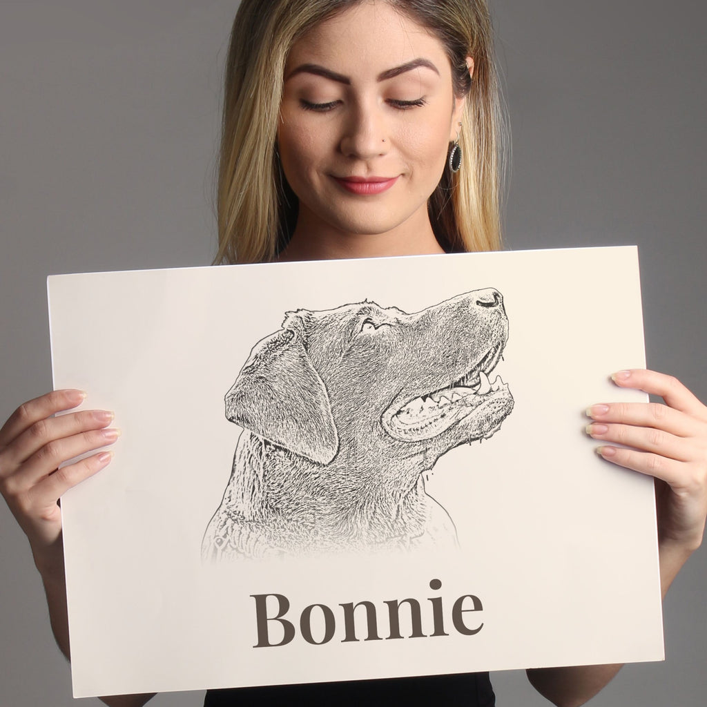 Woman holding an unframed A4 pencil-style dog portrait print with the name Bonnie